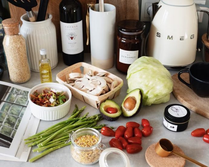 A variety of fresh ingredients and kitchen tools for preparing a healthy meal.