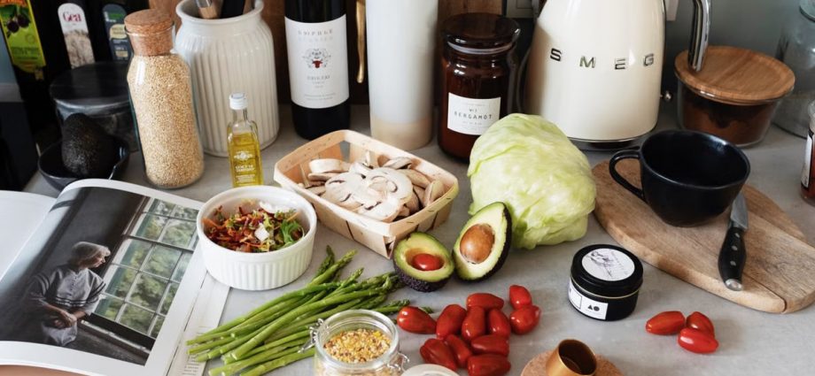 A variety of fresh ingredients and kitchen tools for preparing a healthy meal.